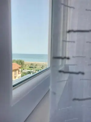 a window with a view of the ocean at A casa di Mamma in Palermo