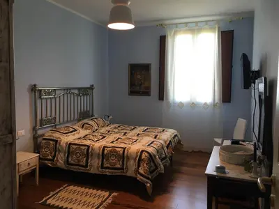 a bedroom with a bed and a window at Baglio Buccellato in Scopello