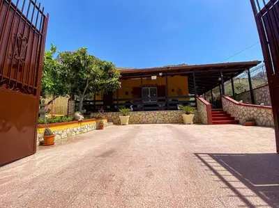 a house with a yellow truck parked in a building at Casa Vacanze Villino Nando in Palermo