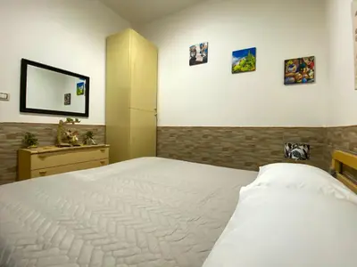 a bedroom with a white bed and a mirror at Casa Vacanze Villino Nando in Palermo
