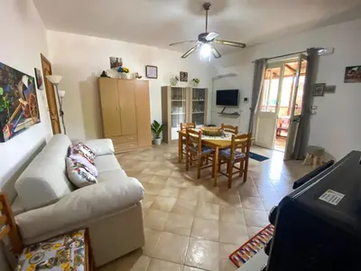 a living room with a couch and a dining room at Casa Vacanze Villino Nando in Palermo