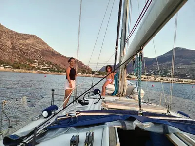 two women standing on a sailboat in the water at Gloria Sailing in Castellammare del Golfo