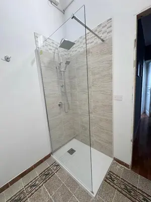a shower with a glass door in a bathroom at Casetta Alice in Palermo