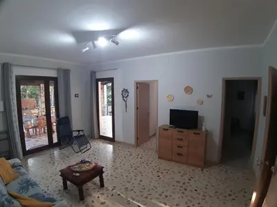 a living room with a couch and a tv on a dresser at Villa L'orizzonte di calabianca in Castellammare del Golfo