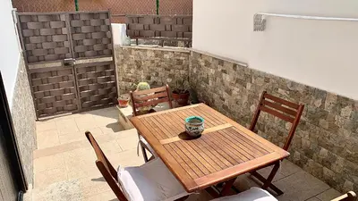 a wooden table and chairs on a patio at Casa Graziella Vacanze in Palermo