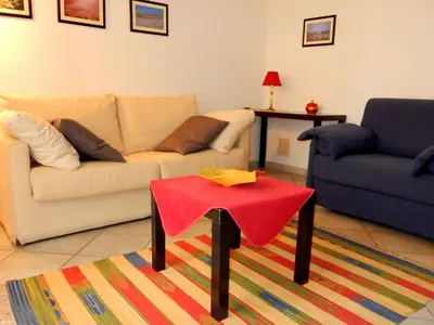 a living room with a couch and a table at Terrasini Siracasa in Terrasini