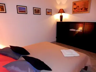 a bedroom with a bed and a tv on the wall at Terrasini Siracasa in Terrasini