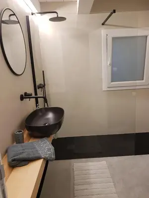 a bathroom with a black sink and a mirror at appartamento politeama in Palermo