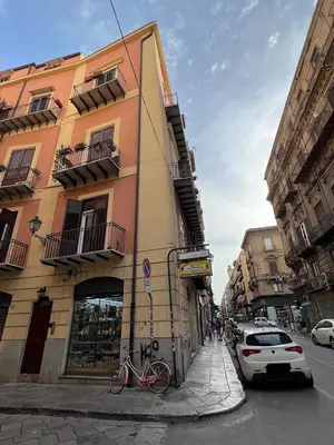 a building on a street with a bike parked next to it at Pothos House in Palermo