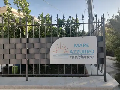 a sign for a mar azurino residence on a fence at Residence Mare Azzurro in Balestrate