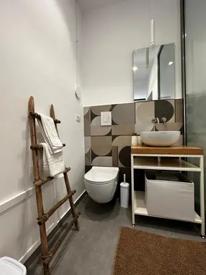 a bathroom with a toilet and a sink and a mirror at Le Gemelle Diverse in Cinisi