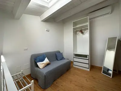 a living room with a couch and a mirror at Le Gemelle Diverse in Cinisi