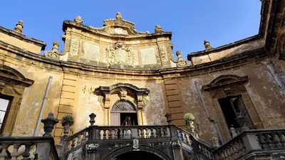 a building with a door and stairs next to it at La Casetta Nell' Atrio Cavalieri in Bagheria