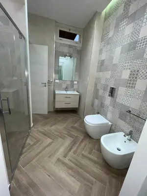 a bathroom with a toilet and a sink and a shower at I Faraglioni Comfort Rooms in Terrasini