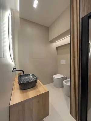 a bathroom with a sink and a toilet at I Faraglioni Comfort Rooms in Terrasini