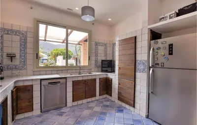 a kitchen with a refrigerator and a window at Gorgeous Home In Terrasini in Terrasini