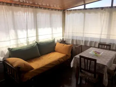 a couch sitting in a room with a table at La casa di Maria in Isola delle Femmine