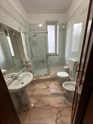 a bathroom with a sink and a toilet and a shower at La casa di Maria in Isola delle Femmine