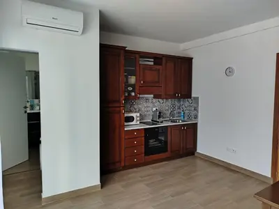 an empty kitchen with wooden cabinets and appliances at Mondello Sea House in Palermo