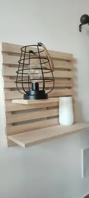 a lamp on a wooden shelf with a cup at Easy Room Holiday in Castellammare del Golfo