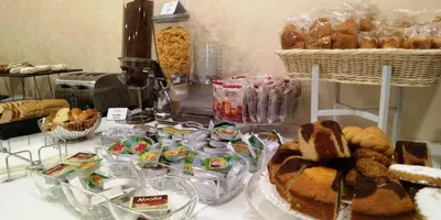 a table topped with lots of different types of pastries at Hotel La Martinica in Ficarazzi