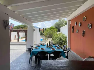 a table with a blue table cloth on a patio at Villa Elloise in Palermo
