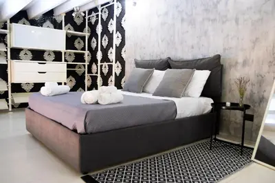 a bedroom with a bed with two towels on it at Pozzillo appartament -near the cathedral in Monreale