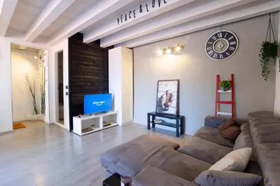 a living room with a couch and a tv at Pozzillo appartament -near the cathedral in Monreale