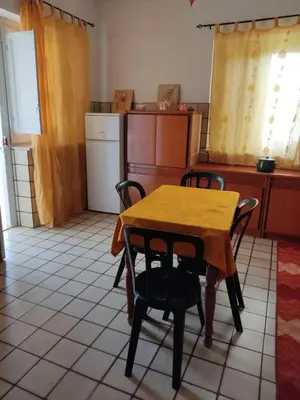 a kitchen with a table and some chairs and a table and a kitchen at sizilien in Trappeto