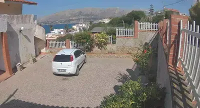a white car parked in a parking lot at sizilien in Trappeto