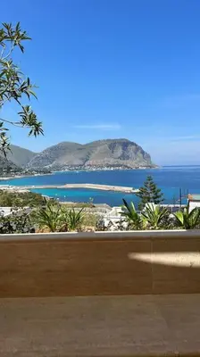 a view of the ocean and a beach with a mountain at La Scalinatella di Mondello in Palermo