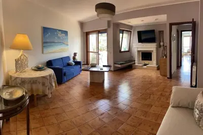 a living room with a blue couch and a fireplace at La Scalinatella di Mondello in Palermo