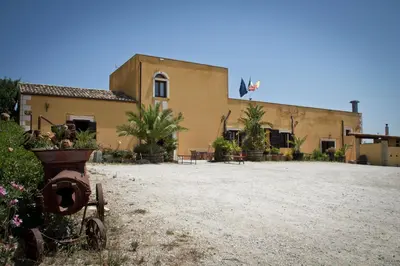a building with a fire hydrant in front of it at Baglio Pocoroba in Calatafimi