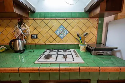 a kitchen counter with a stove top in a kitchen at Tri Re e 'na Regina in Cinisi