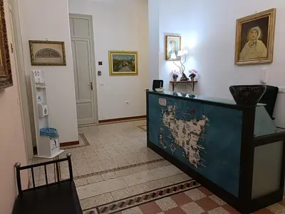 a room with a dresser with a painting on the wall at DayBreak B&B in Palermo