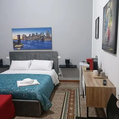 a bedroom with a bed and a red couch at DayBreak B&B in Palermo