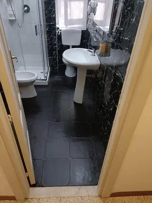 a bathroom with a sink and a toilet at DayBreak B&B in Palermo