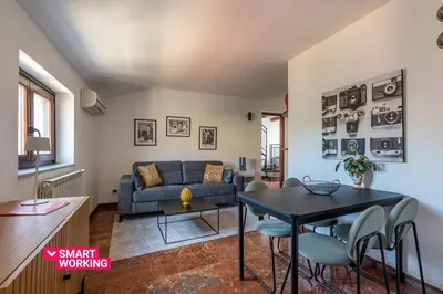 a living room with a blue couch and a table at Le terrazze nel cuore della Kalsa by Wonderful Italy in Palermo