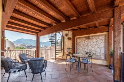 a patio with chairs and a table on a balcony at Le terrazze nel cuore della Kalsa by Wonderful Italy in Palermo
