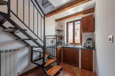 a kitchen with a spiral staircase in a house at Le terrazze nel cuore della Kalsa by Wonderful Italy in Palermo