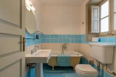 a bathroom with a tub and a sink and a toilet at Amari Elegant Apartment by Wonderful Italy in Palermo