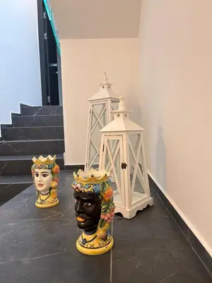 two vases on display in a room with stairs at Sicilian Paradise Casa Vacanze in Castellammare del Golfo