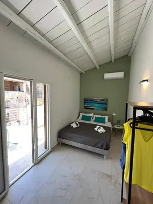 a bedroom with a bed and a large window at Sicilian Paradise Casa Vacanze in Castellammare del Golfo
