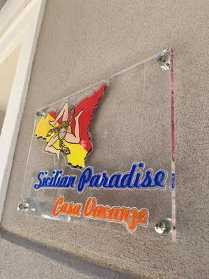 a sign on the side of a house with the sign for sittin paradise at Sicilian Paradise Casa Vacanze in Castellammare del Golfo