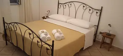 a bedroom with a bed with towels on it at AI CANTIERI in Palermo
