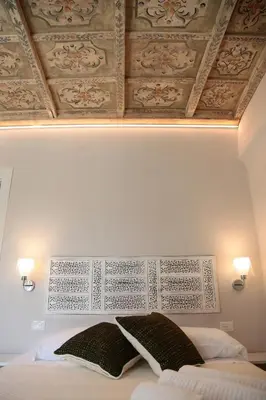 a bedroom with a bed with two pillows on it at Alle Absidi della Cattedrale in Palermo