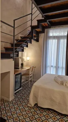 a bedroom with a bed and a staircase at Alle Absidi della Cattedrale in Palermo