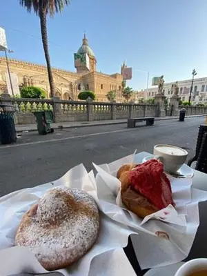 two pastries sitting on a table on a street at Alle Absidi della Cattedrale in Palermo