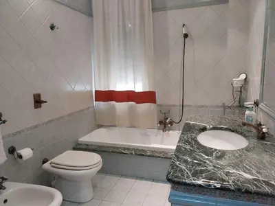 a bathroom with a tub and a toilet and a sink at ROOM VISTAMARE PALERMO in Palermo