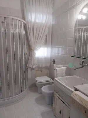 a white bathroom with a toilet and a sink at ROOM VISTAMARE PALERMO in Palermo